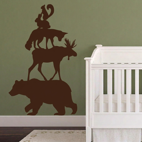 Dark chocolate-brown woodland animal decals on an olive-green wall with the stool removed
