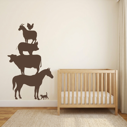 Stacked brown farm animal decals in a warm ivory farmhouse nursery with an oak crib
